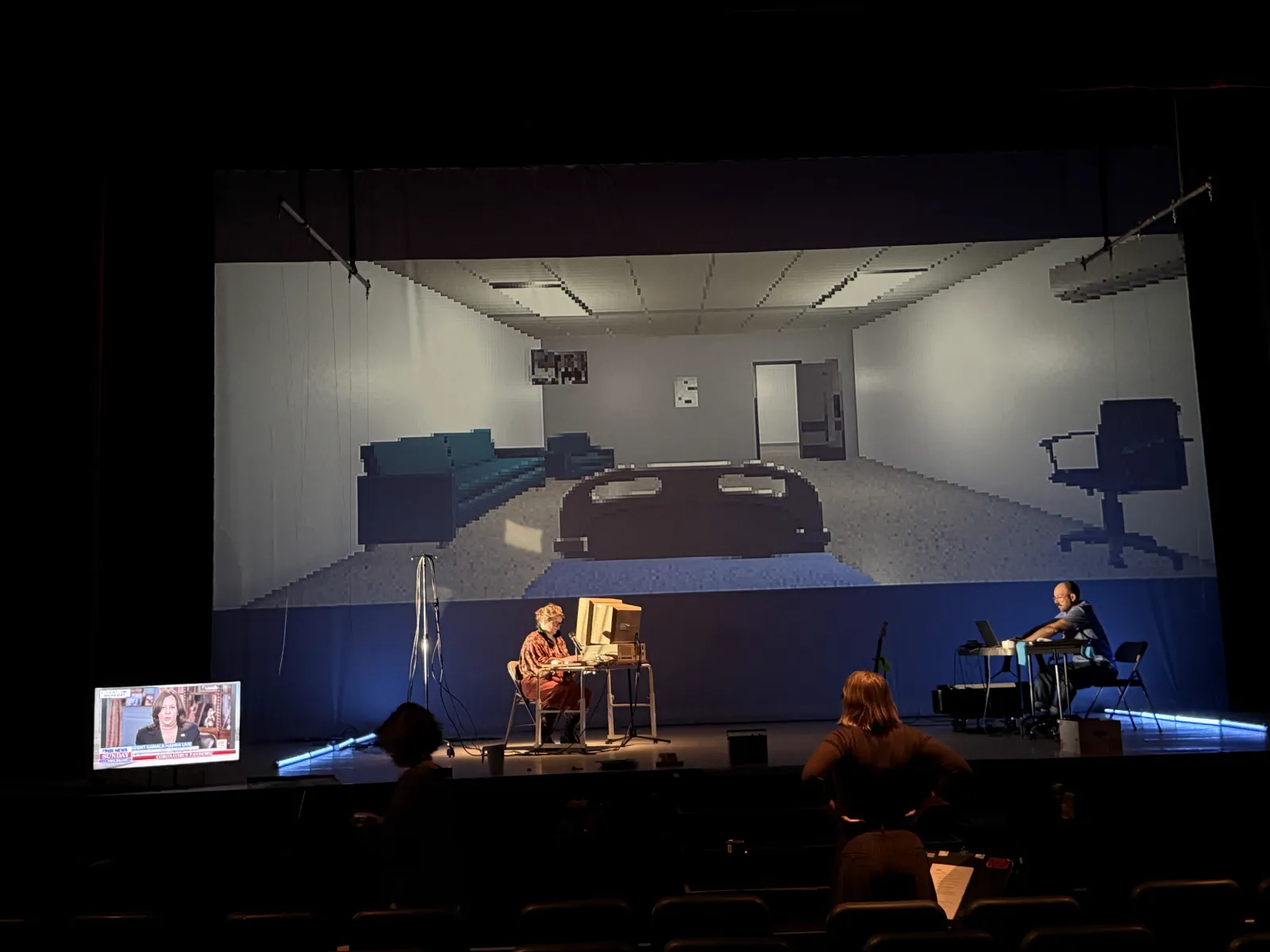2021: the same hospital room as an empty 3D space, projected wide, a television at the front of the stage