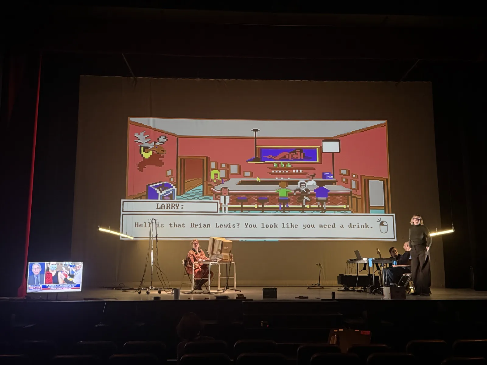 2021: a pixel-art bar projected across the back wall, a dialogue box reading “Hell is that Brian Lewis? You look like you need a drink.”, the player at a desk below