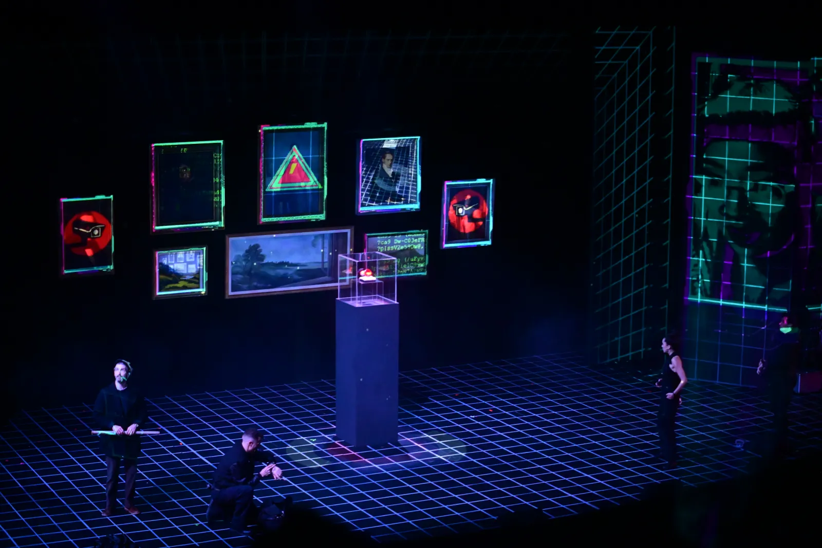 Heist: a gallery of projected frames around a ruby on a pedestal, the crew moving across the gridded floor