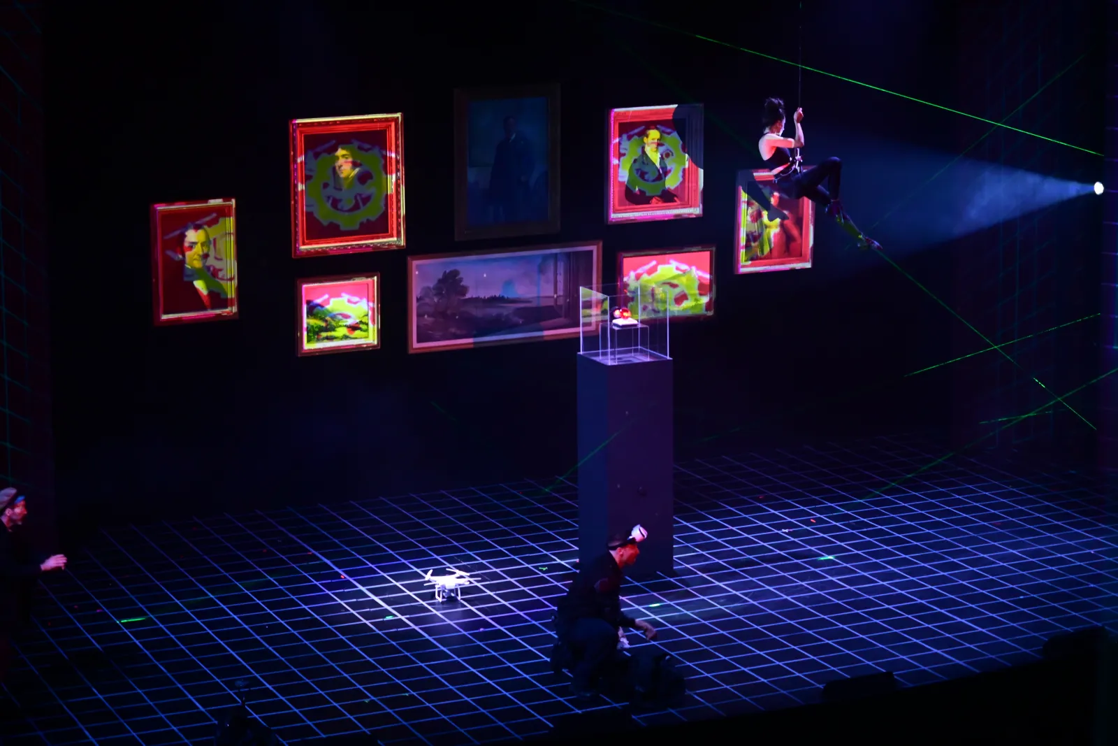 Heist: the gallery’s frames turned red and green, an aerialist at the right, the ruby’s case on its pedestal