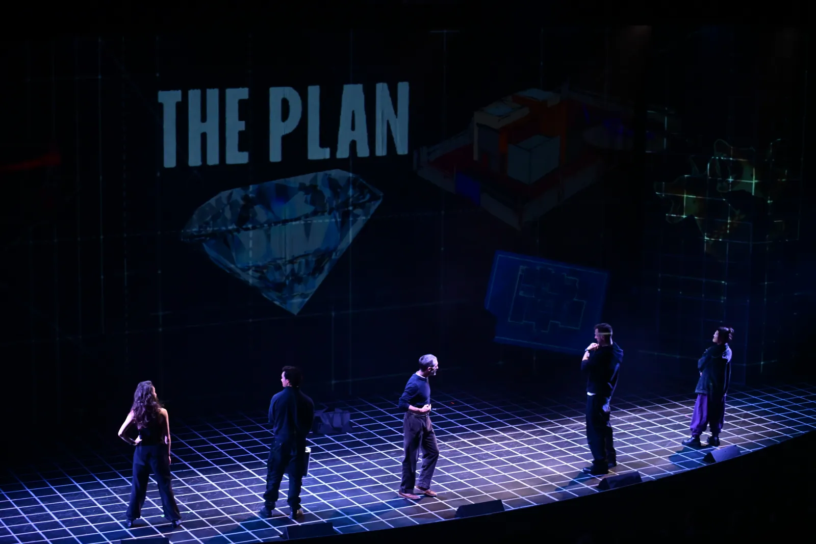 Heist: “The Plan” and a diamond projected over the stage, the cast in a line below