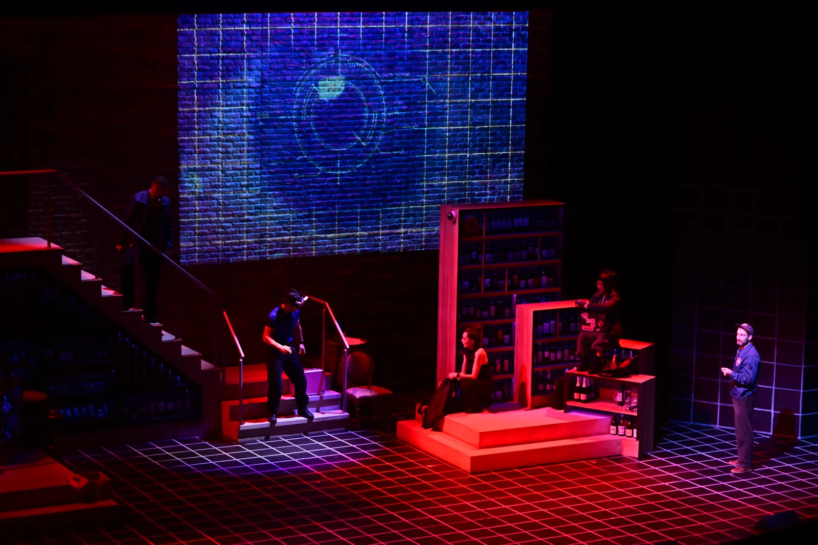Heist: a blue projected eye above the set, red light on the stairs