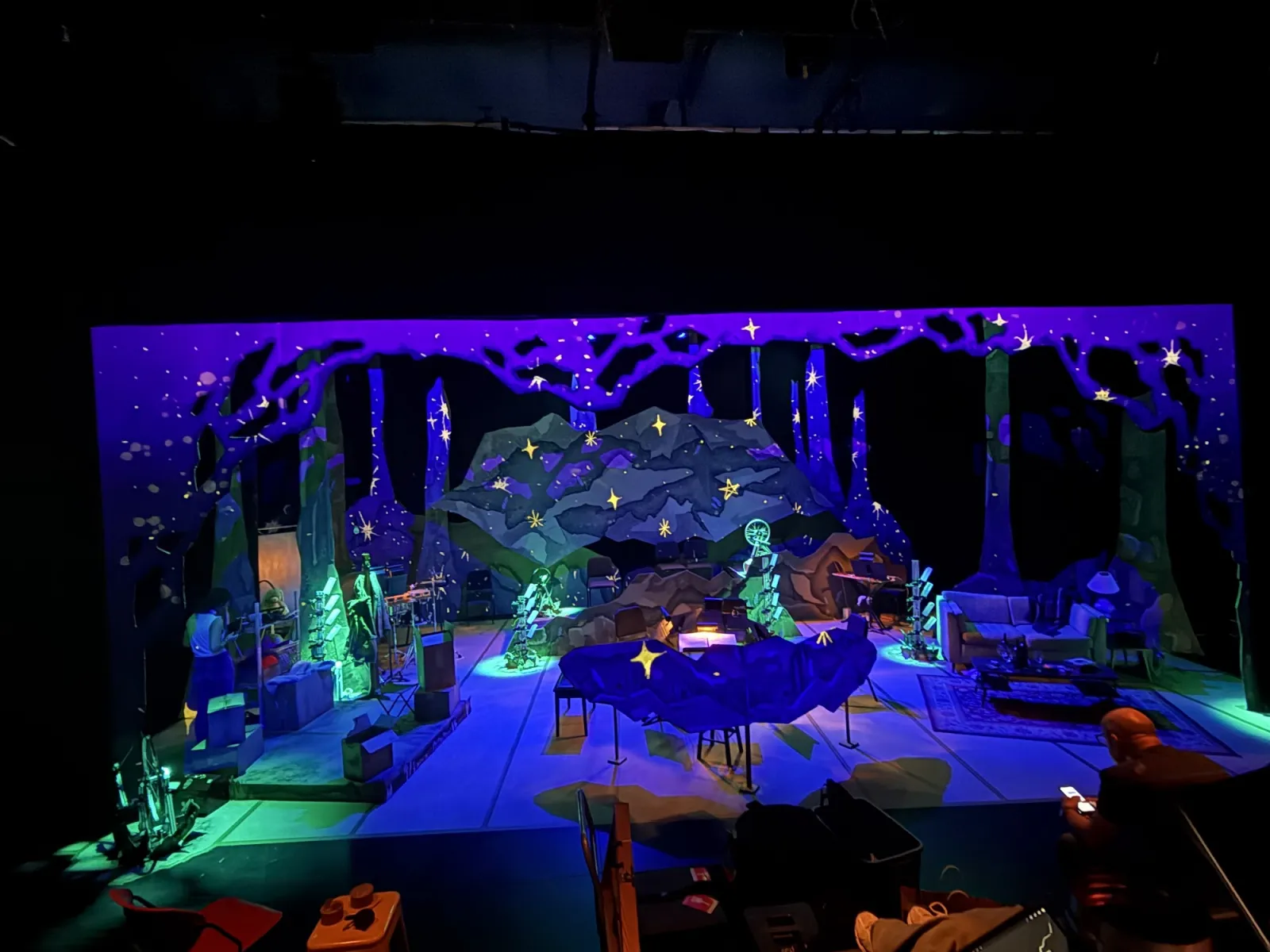 Sophia’s Forest stage environment under ultraviolet light with painted forest scenery and sound sculptures