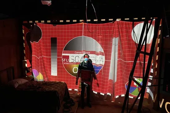 The Mountaintop: a test pattern projected on the hanging screen above the bed, a person standing in front of it